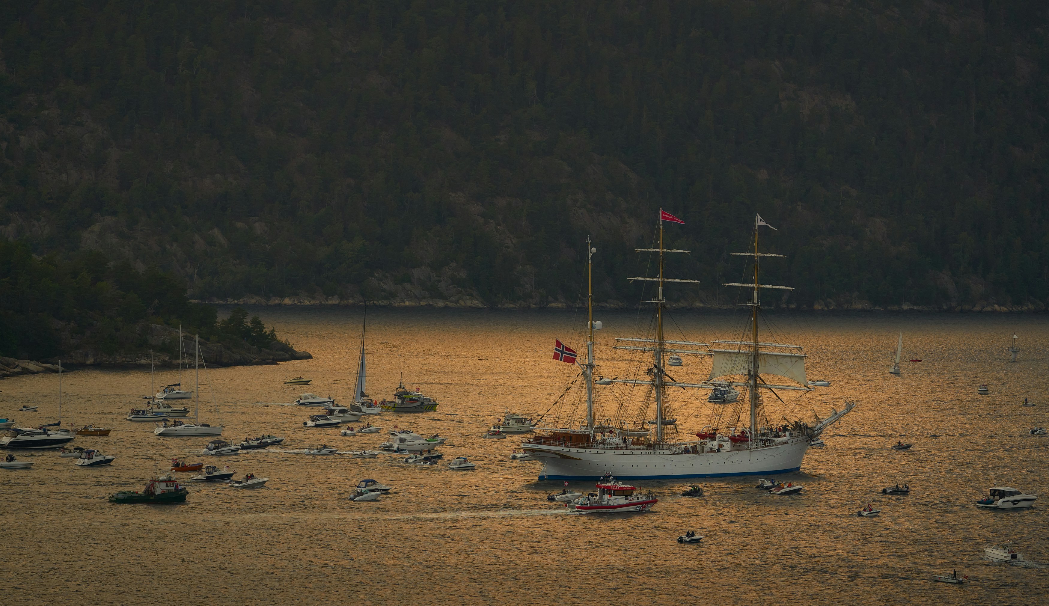 white sail boat on sea shore during daytime