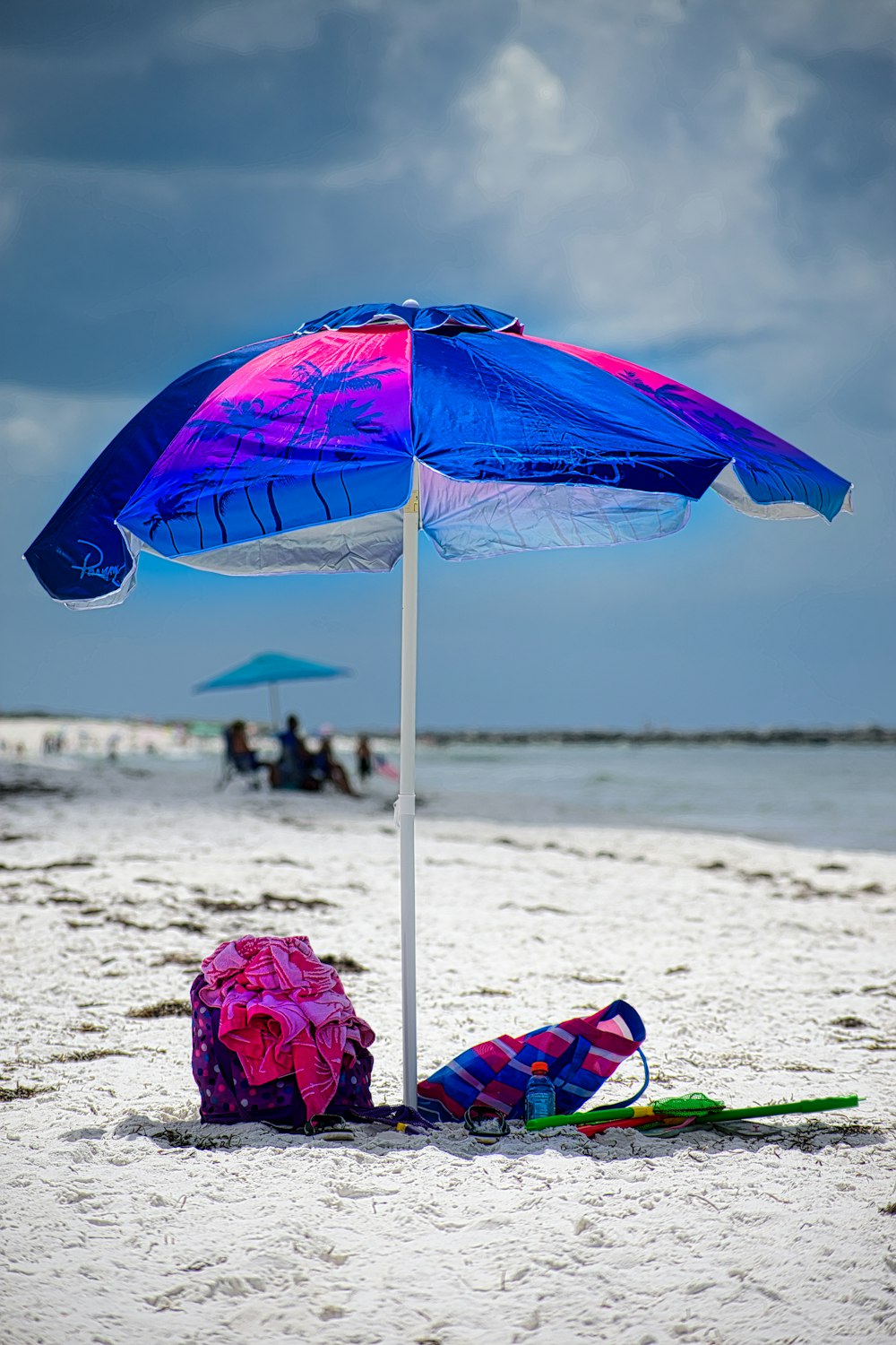 blue umbrella on beach during daytime