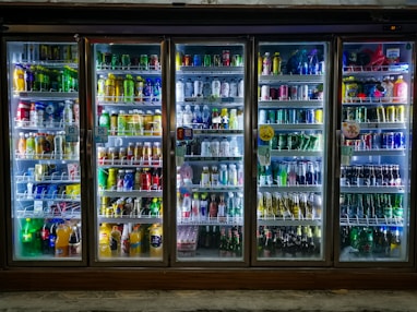assorted bottles in glass shelf
