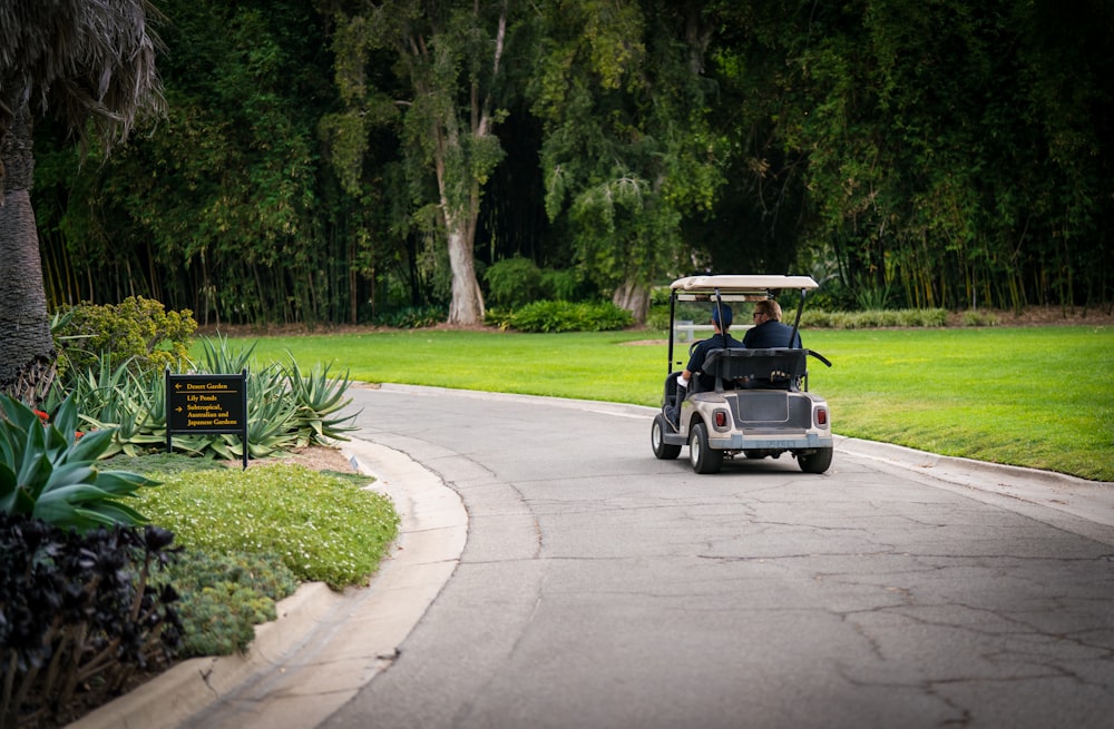 white golf cart on road during daytime