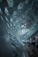 Architectural shot of perforated metal ceiling in a bright interior space.