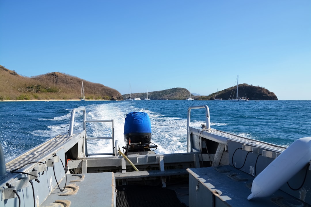 blue and white boat on sea during daytime