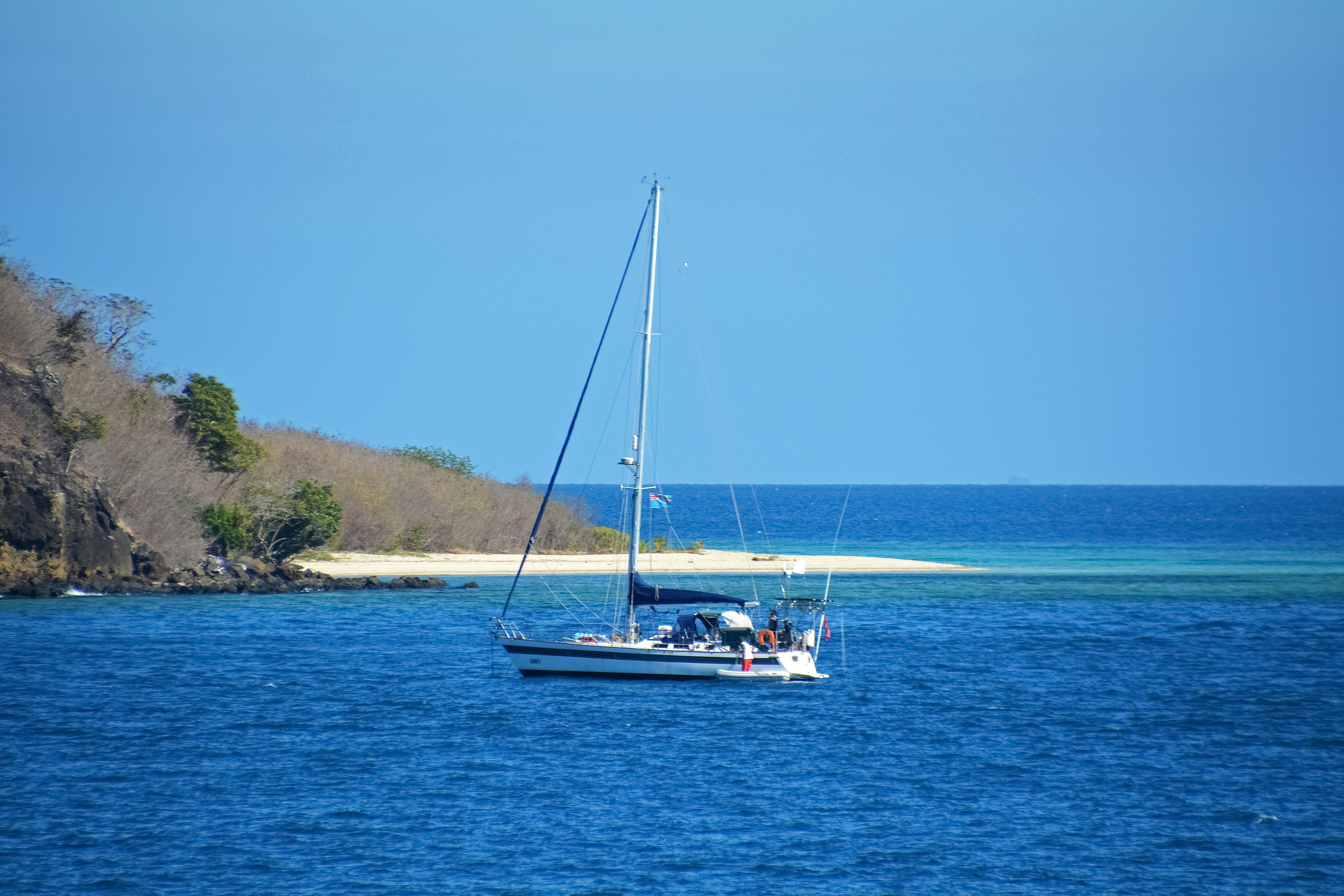 white and blue boat on sea during daytime