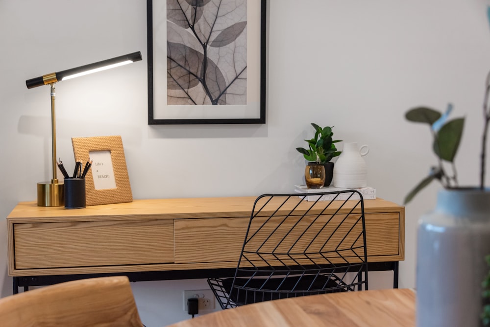 black metal framed white padded chair beside brown wooden table