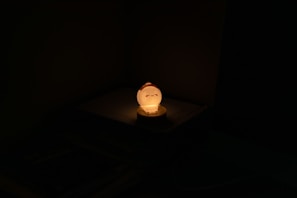 A Korean lightstick glowing softly on a nightstand, creating a cozy atmosphere