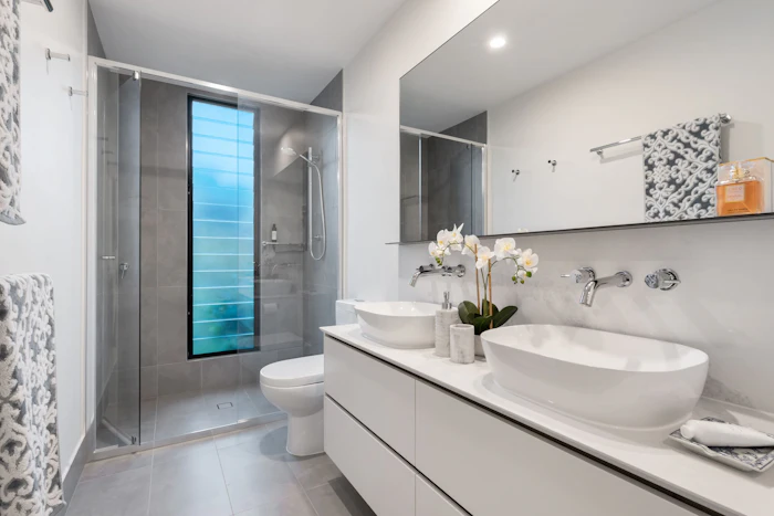Walk-in shower with double vanity and terrazzo tiling