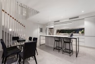 A sleek kitchen with high-quality appliances and a dining set.