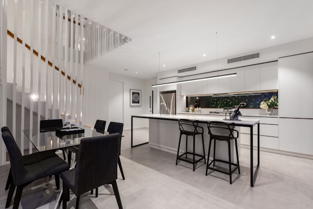 A modern kitchen with custom cabinetry and a stylish dining area.
