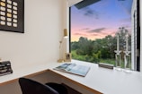 A serene study space with a desk, books, and a plant.
