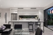 A modern kitchen with sleek finishes and open space, perfect for family gatherings.