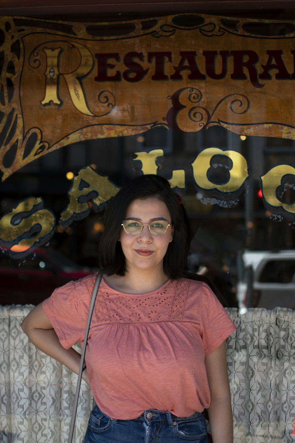 smiling woman in pink crew neck t-shirt wearing black framed eyeglasses