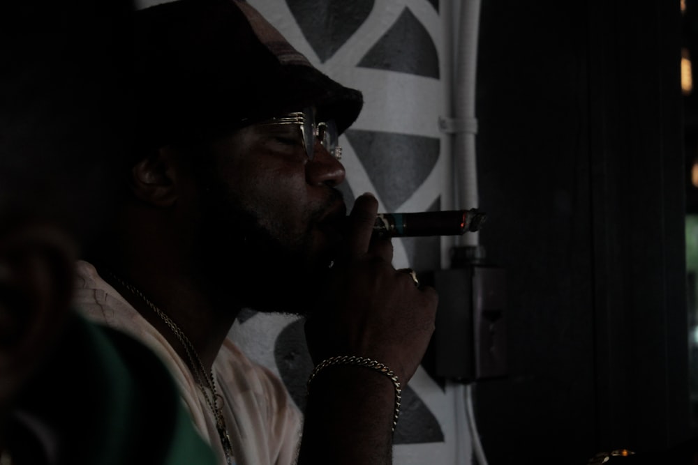 man in white dress shirt smoking cigarette