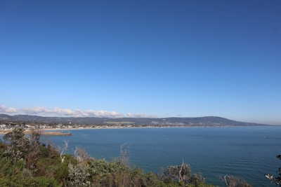 A serene landscape of a coastal town in the northeast region with clear skies.