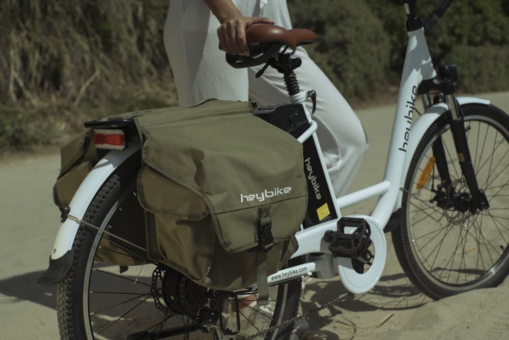 person riding on white and black bicycle