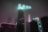 A futuristic cityscape with neon lights and dark blue hues, showcasing a lone figure immersed in a virtual quest.