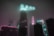 A futuristic cityscape with neon lights and dark blue hues, showcasing a lone figure immersed in a virtual quest.