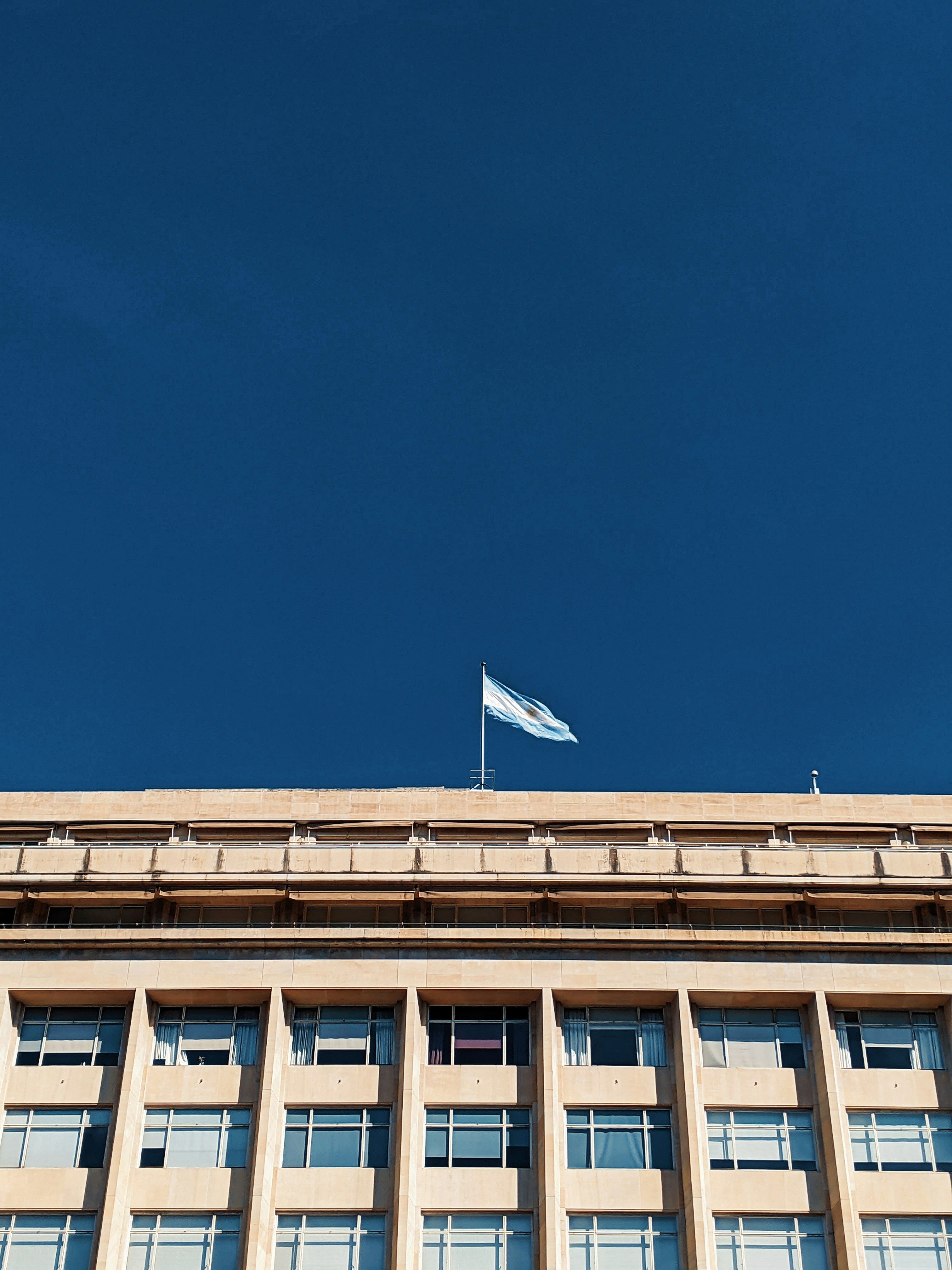 white and blue concrete building under blue sky during daytime