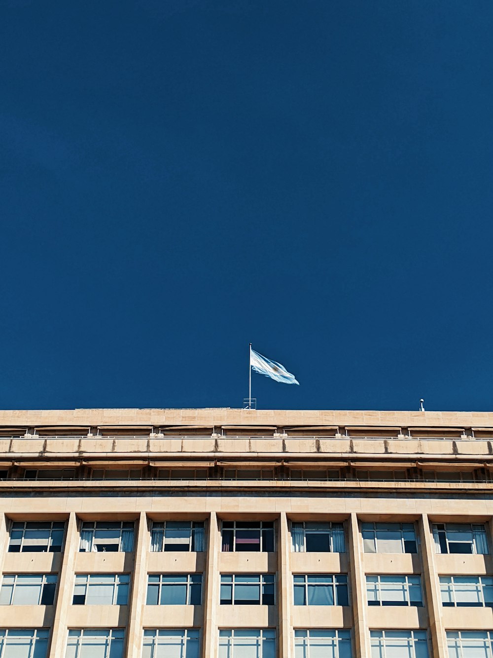 white and blue concrete building under blue sky during daytime