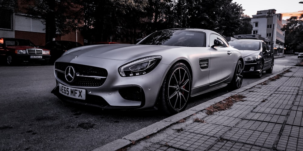 silver mercedes benz coupe parked on gray concrete pavement