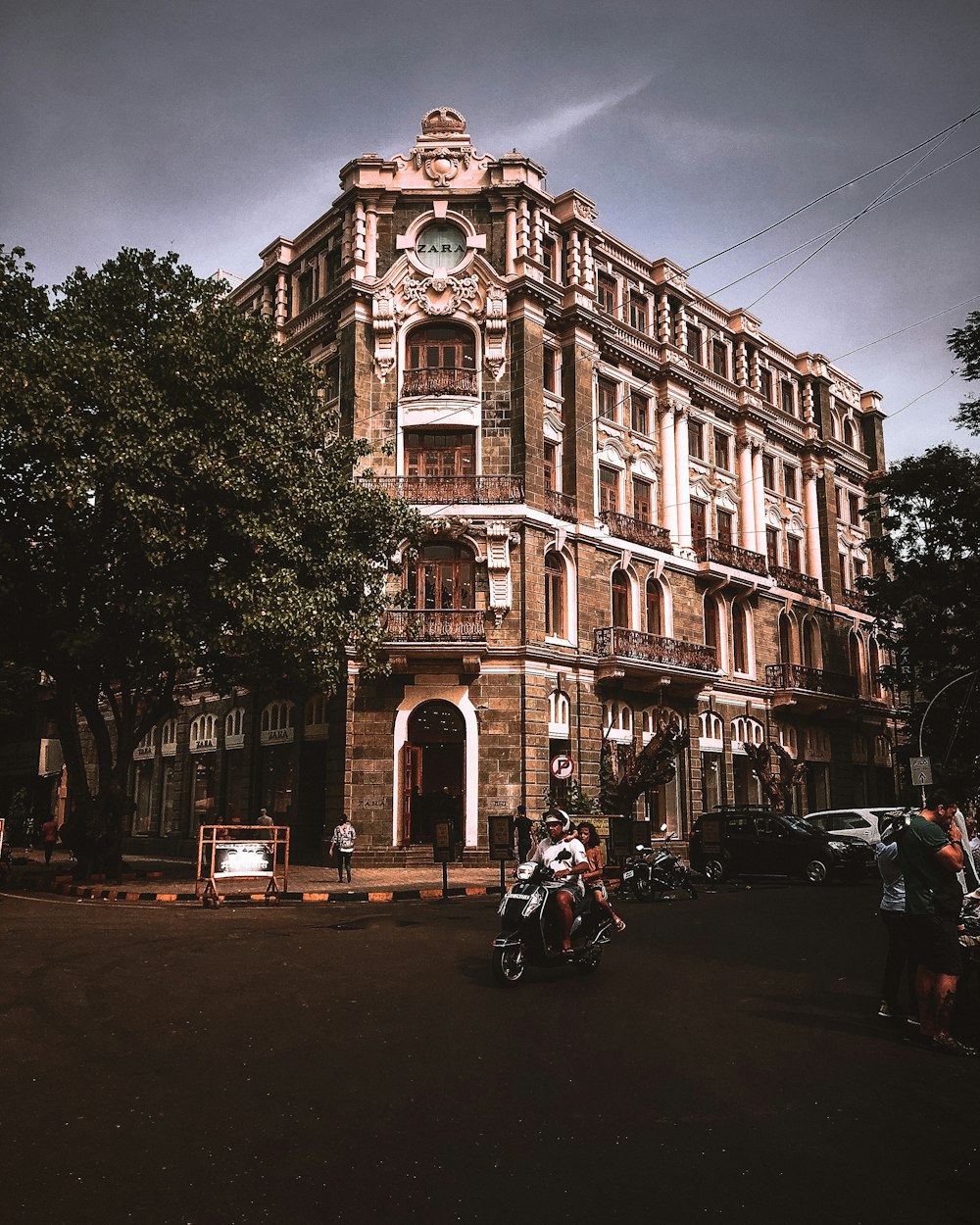 cars parked in front of brown concrete building during daytime