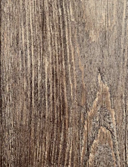 Close-up of a vibrant image being printed on a textured wooden surface.