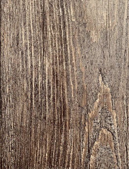 Close-up of a vibrant image being printed on a textured wooden surface.