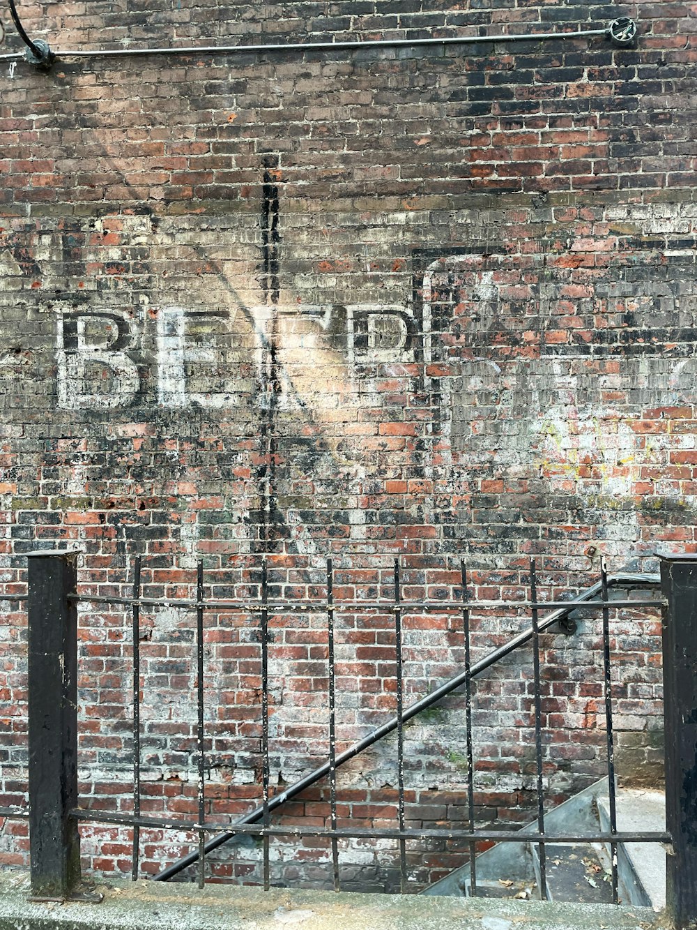 black metal railings on brown brick wall