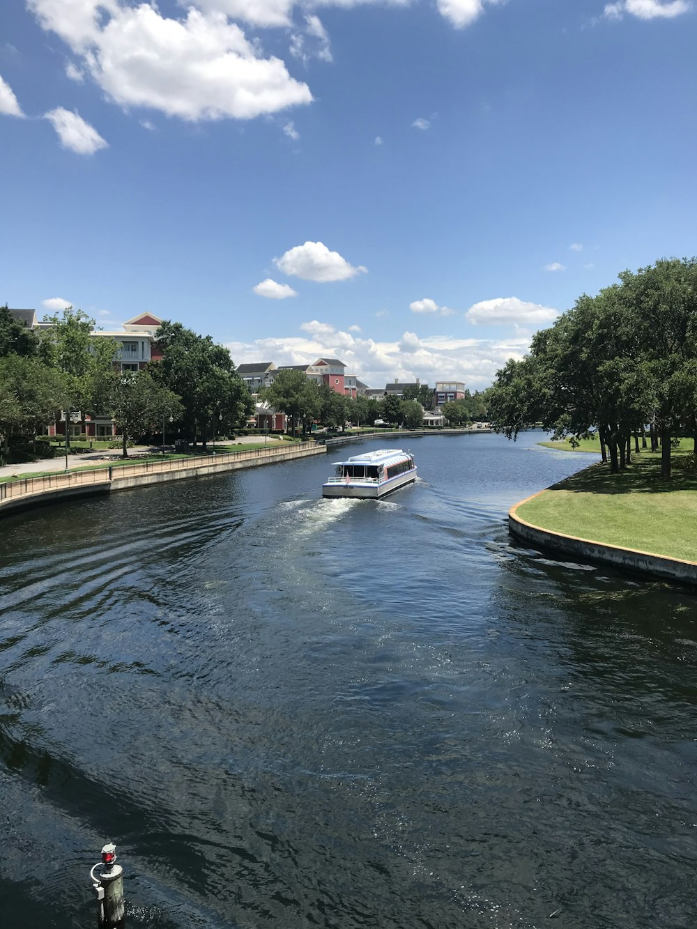 white and blue boat on river during daytime