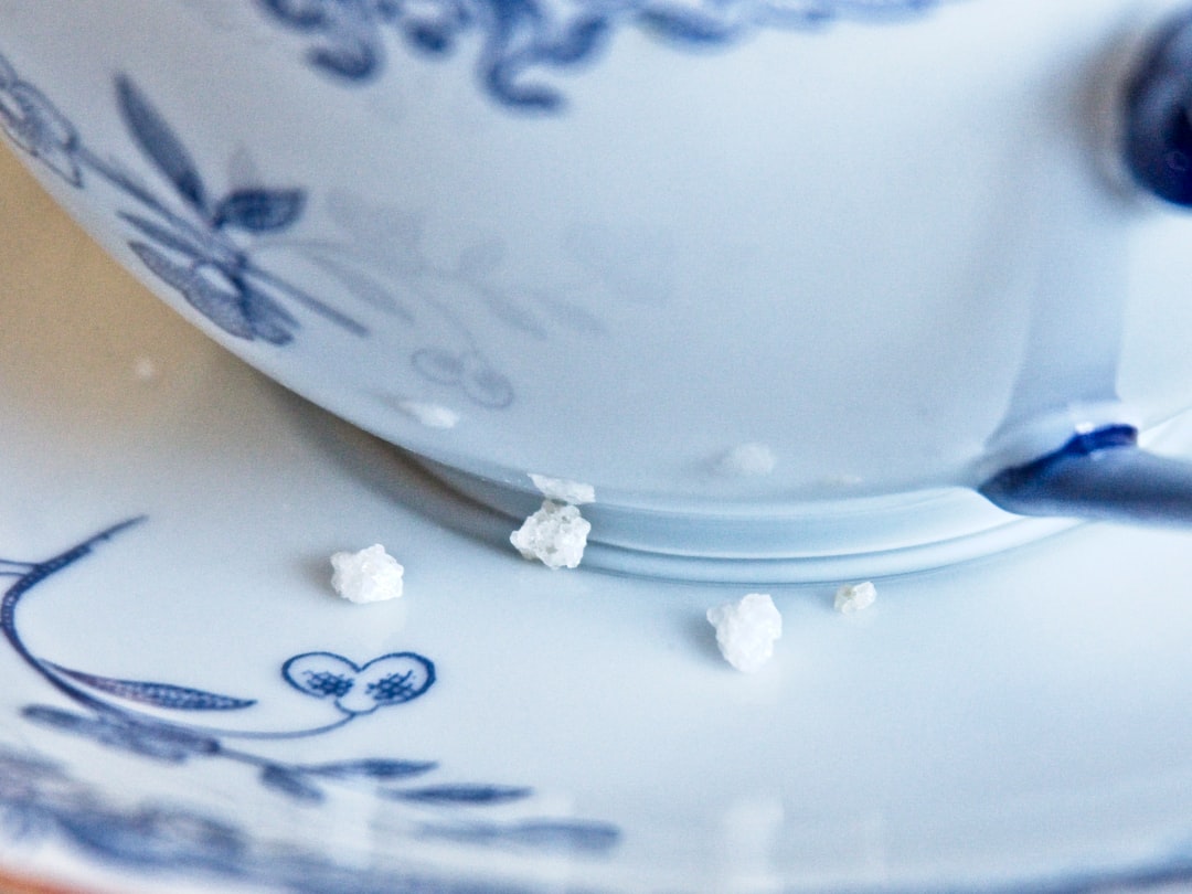 white and blue ceramic teacup on saucer