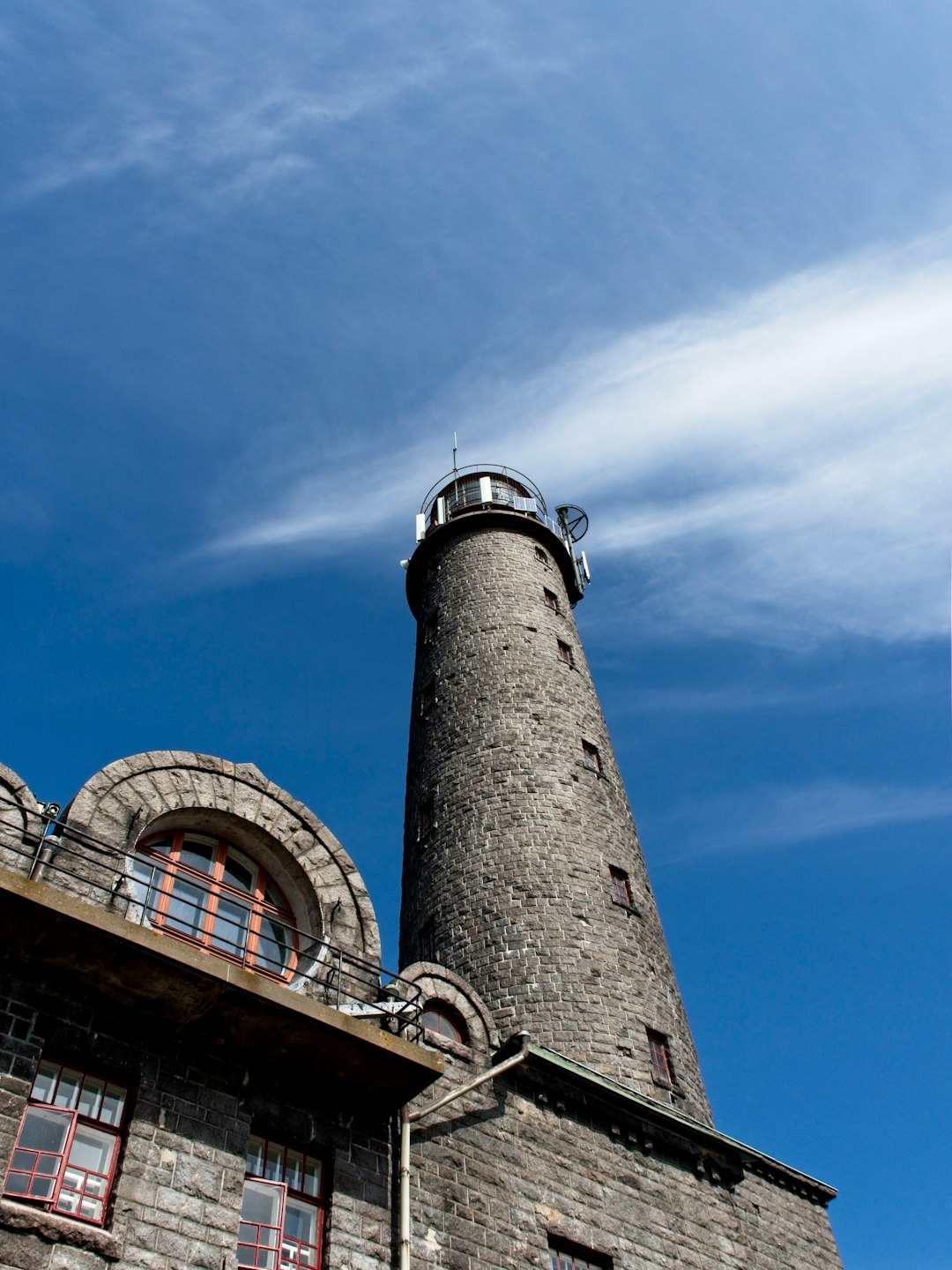 brown and white concrete tower under blue sky during daytime