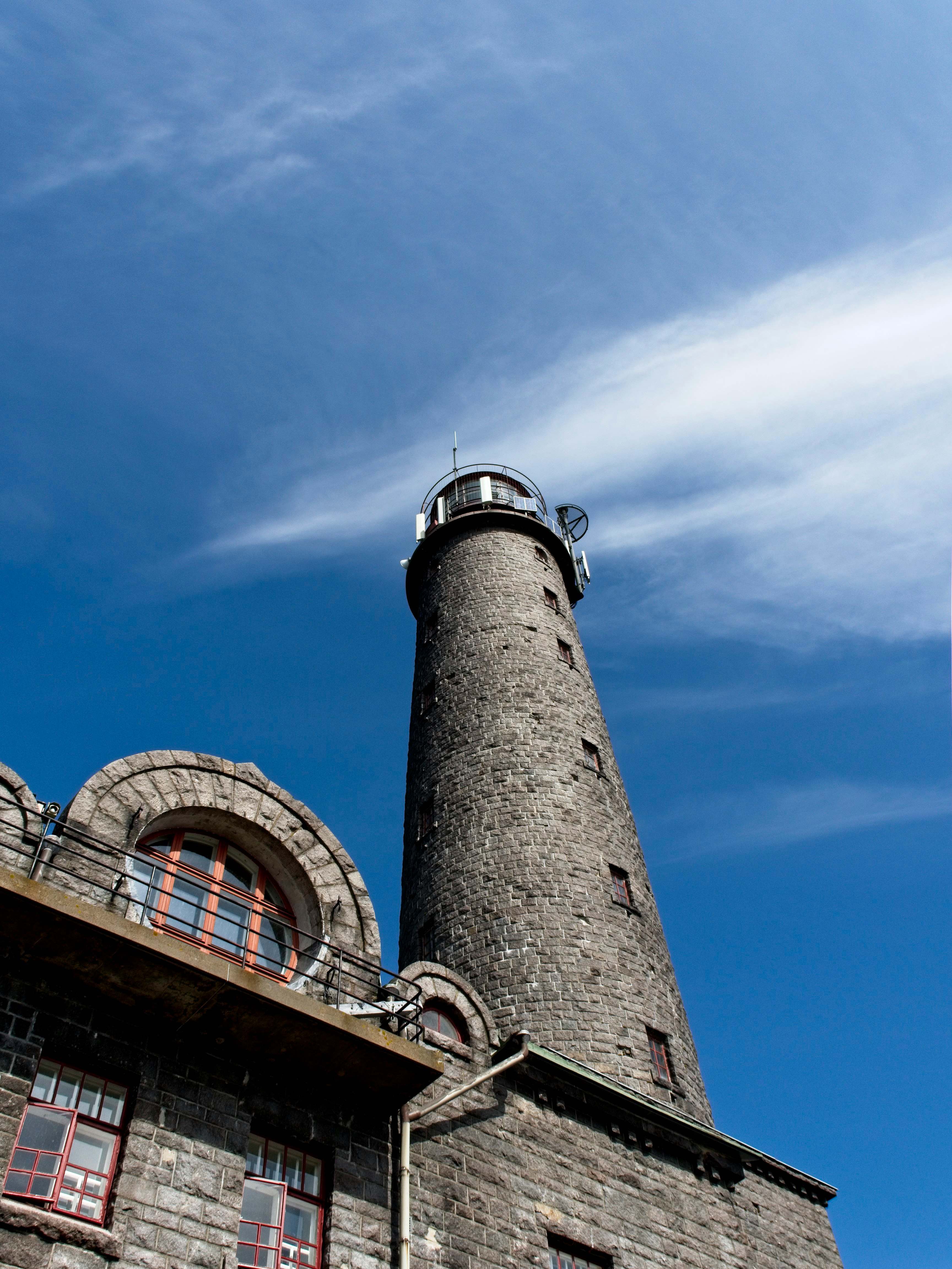 brown and white concrete tower under blue sky during daytime