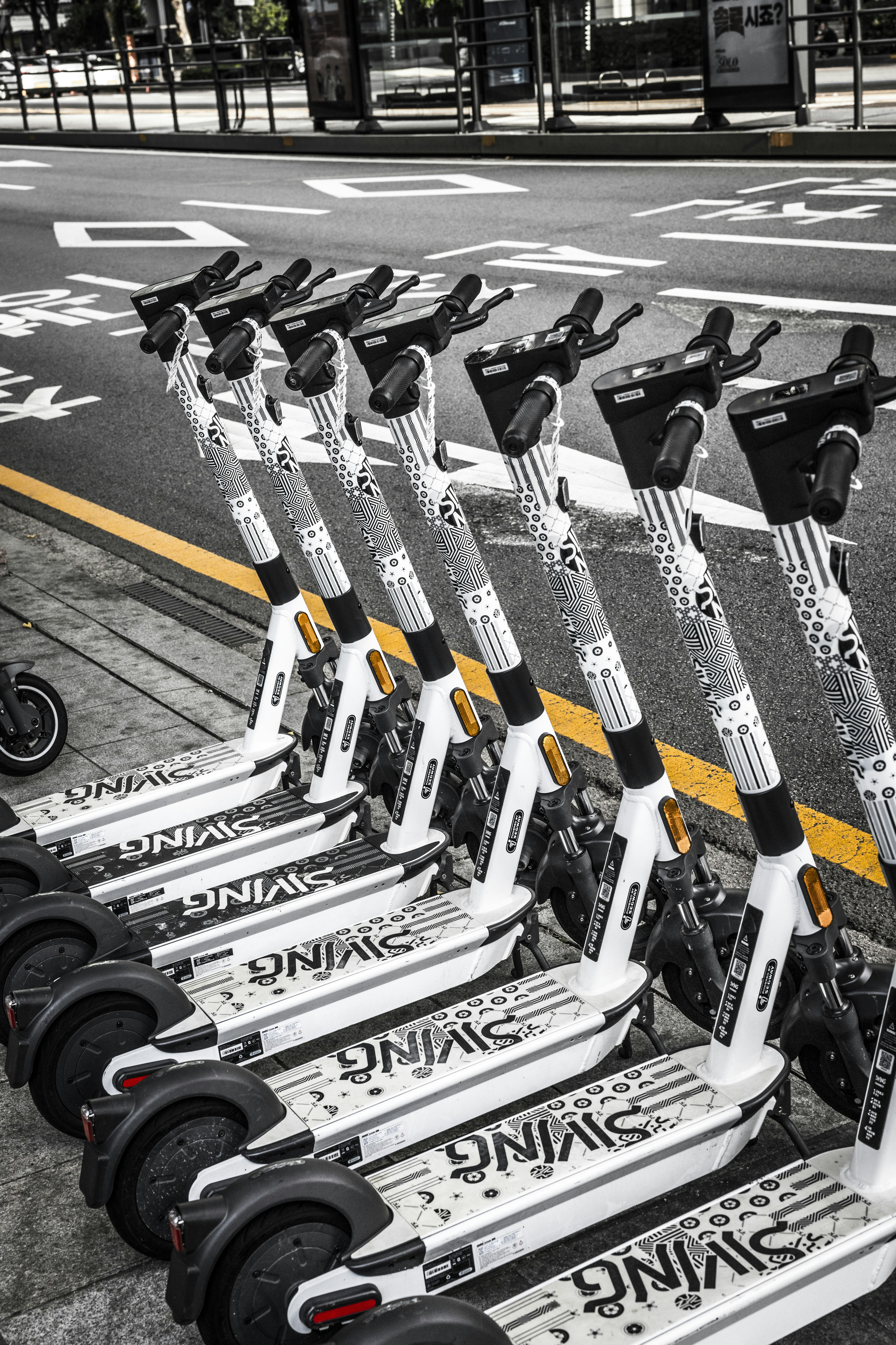 white and black skateboard on black asphalt road