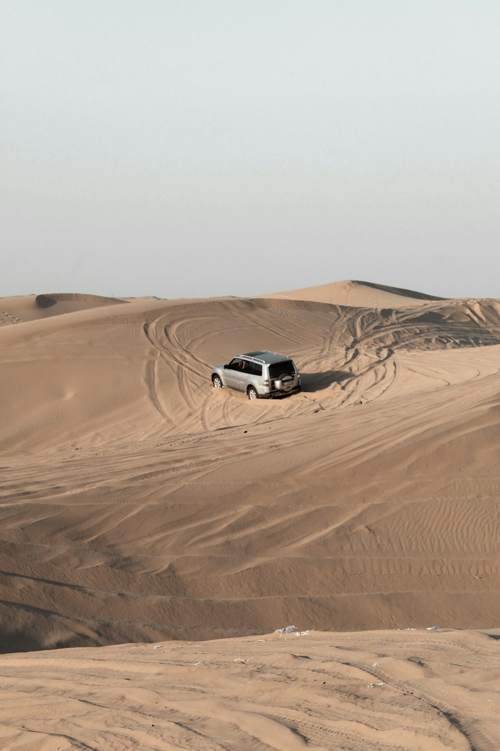 white suv on desert during daytime