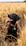 black labrador retriever sitting on brown grass field during daytime