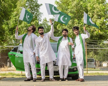 man in white karate gi holding green flag