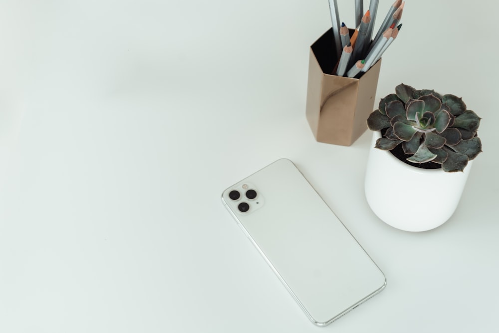 silver iphone 6 on white ceramic mug