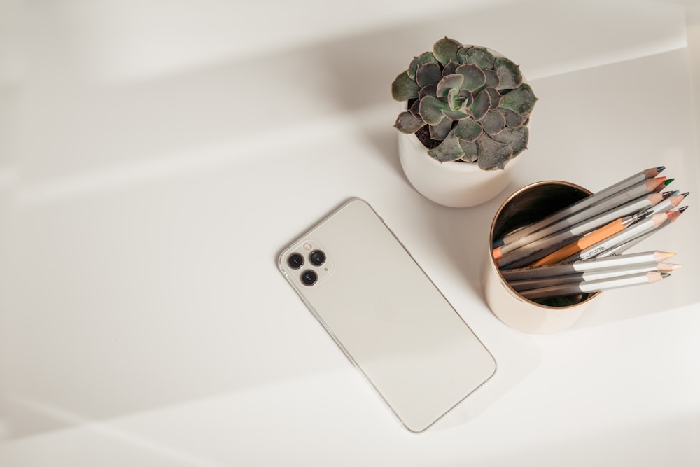 silver iphone 6 on white table