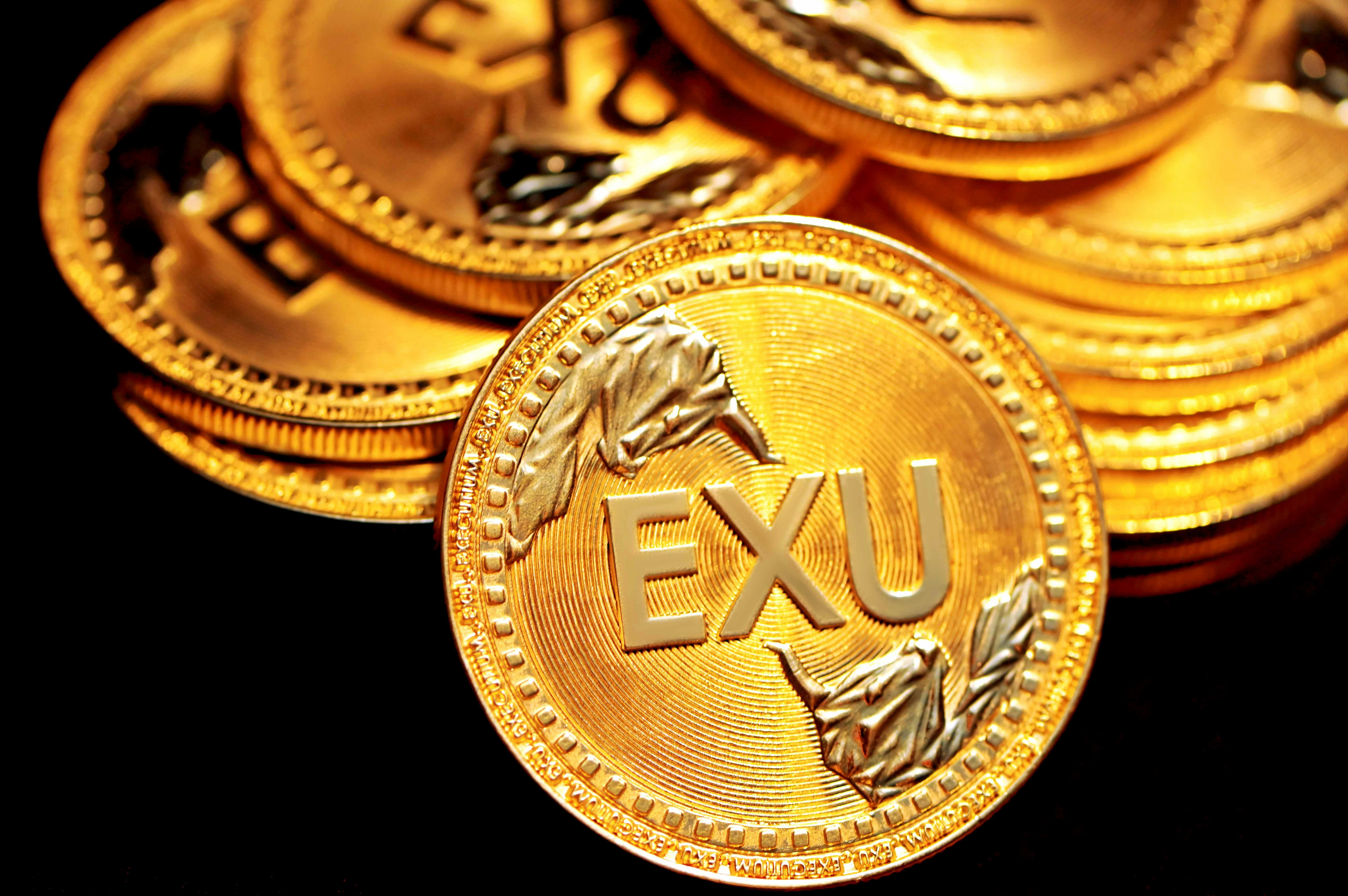 A pile of gold EXU coins are together