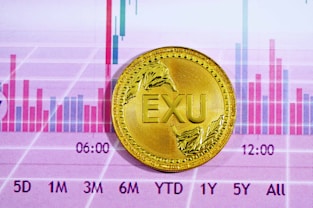 gold round coin on pink and white textile