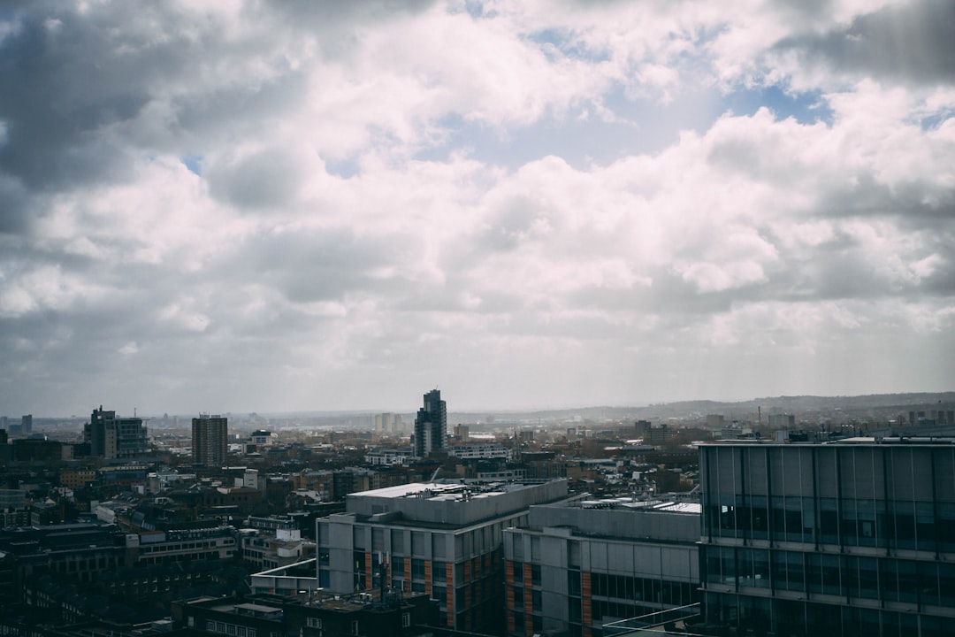 city buildings under white clouds during daytime