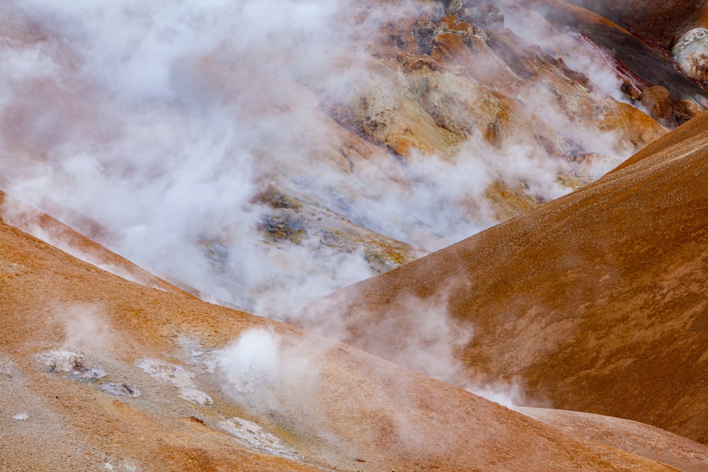 brown and white mountains under white clouds during daytime