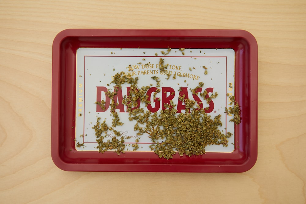 a red tray with a sign that says dag grass on it