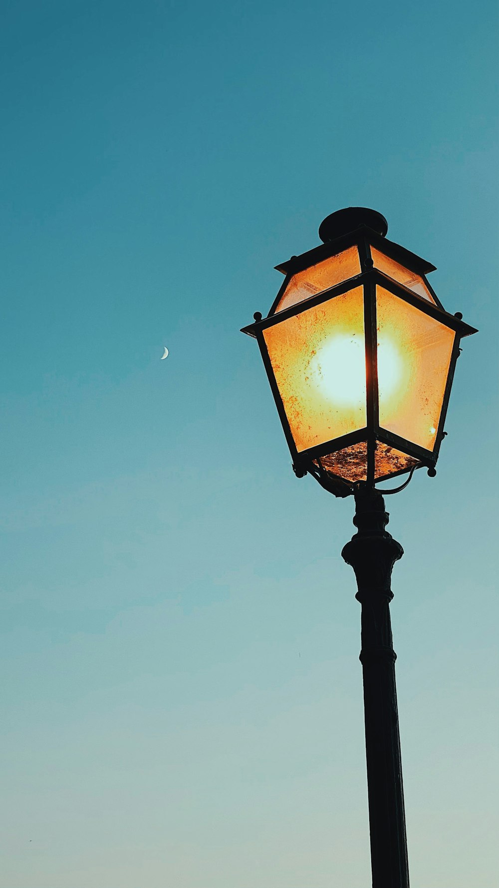 black street lamp turned on during night time