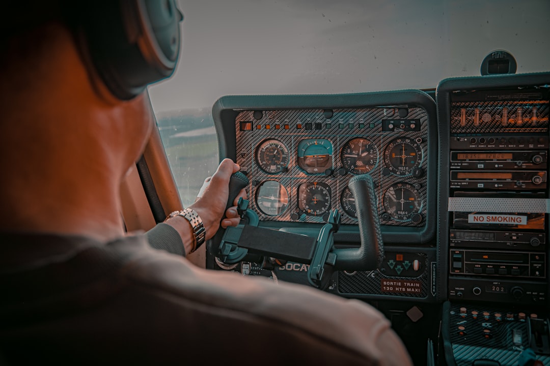 person holding black and green car steering wheel