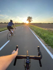 man in black shirt riding bicycle on road during daytime