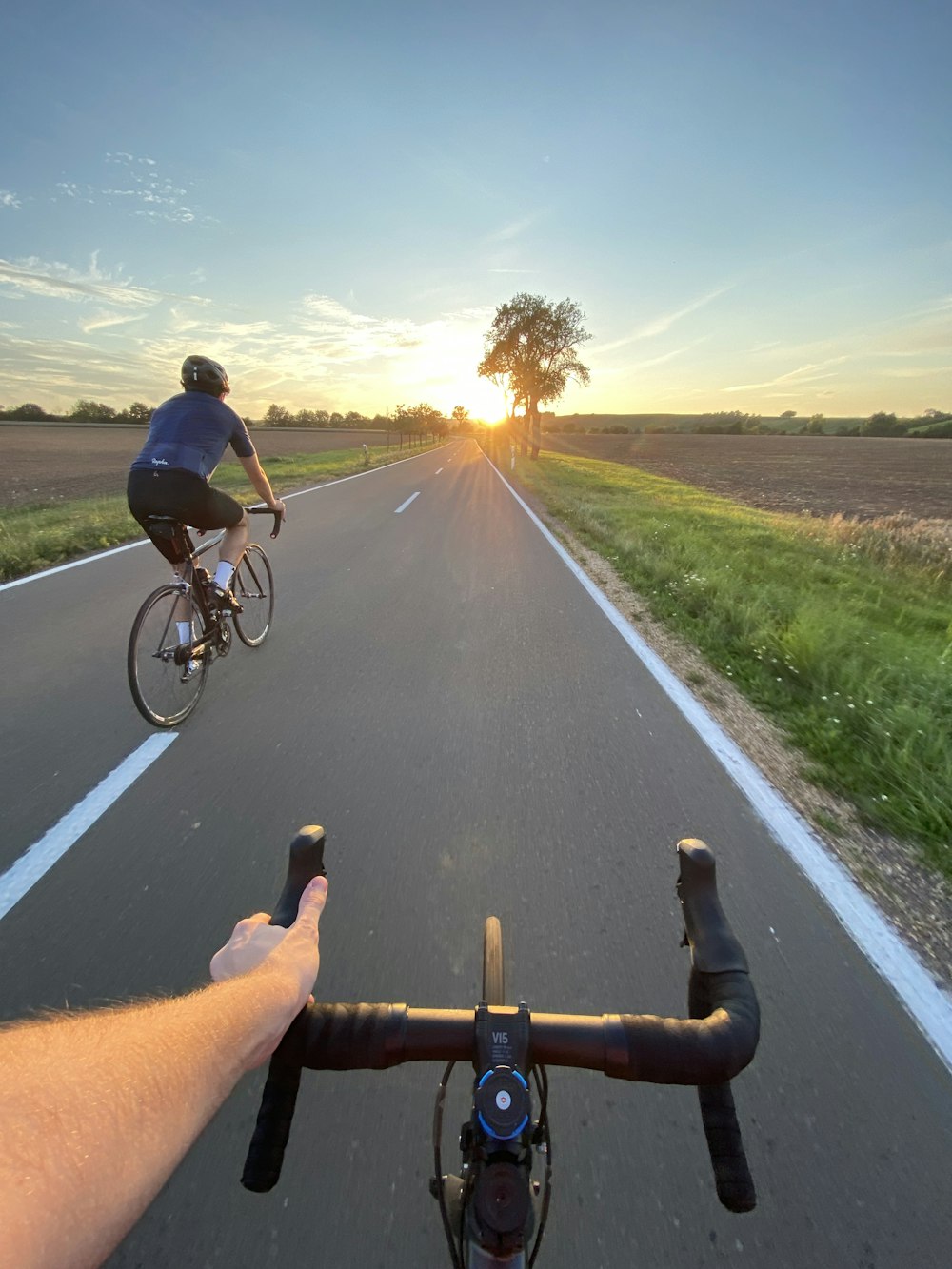 man in black shirt riding bicycle on road during daytime
