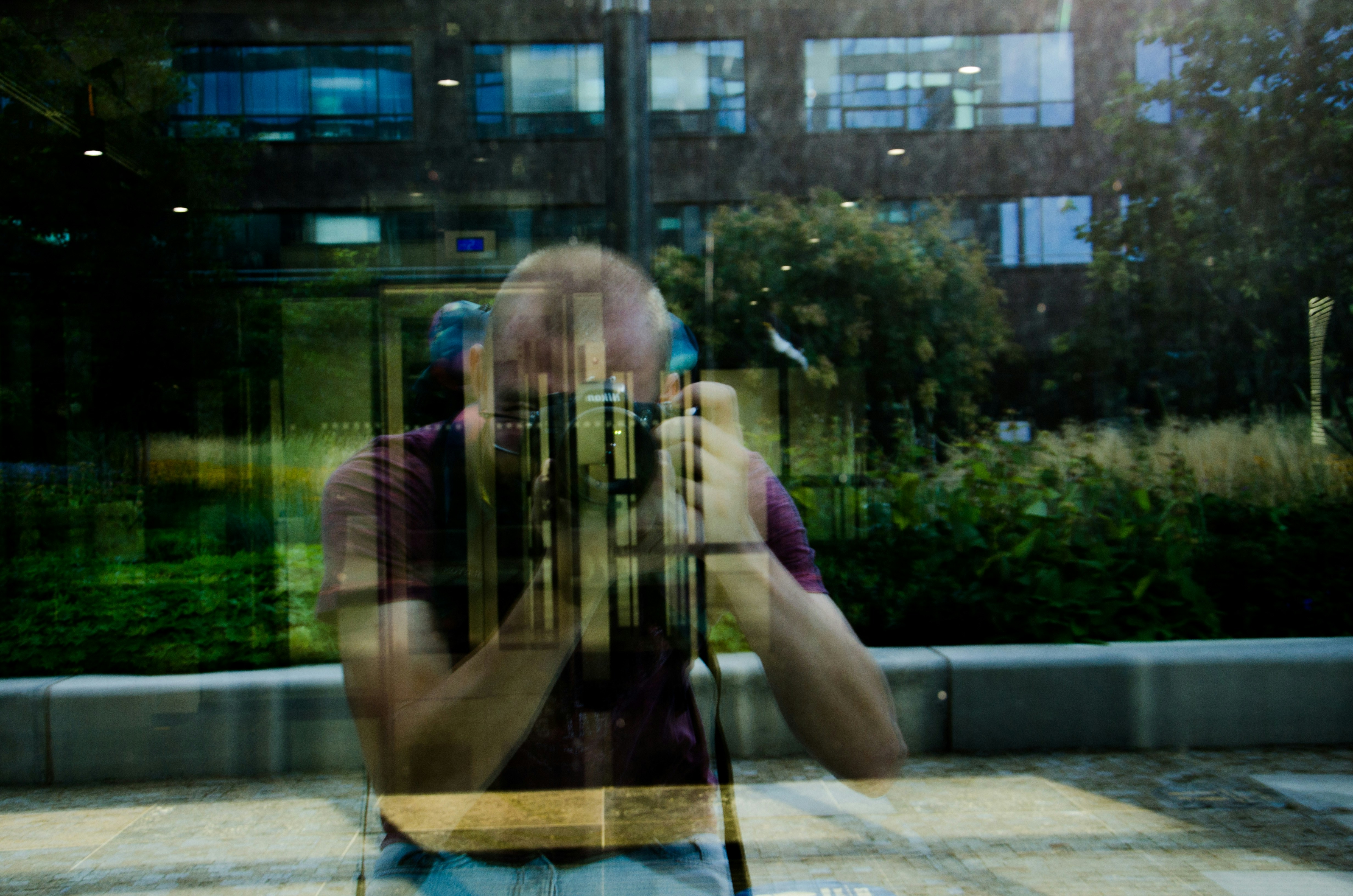 A person looking confused or frustrated while holding a phone, with a blurred background suggesting a chaotic or busy environment
