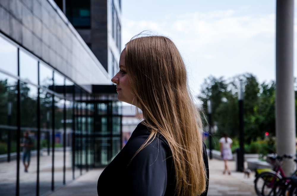 woman in black shirt standing near building during daytime