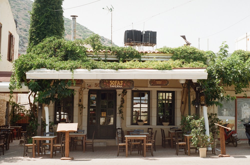 brown wooden chairs and tables outside building during daytime