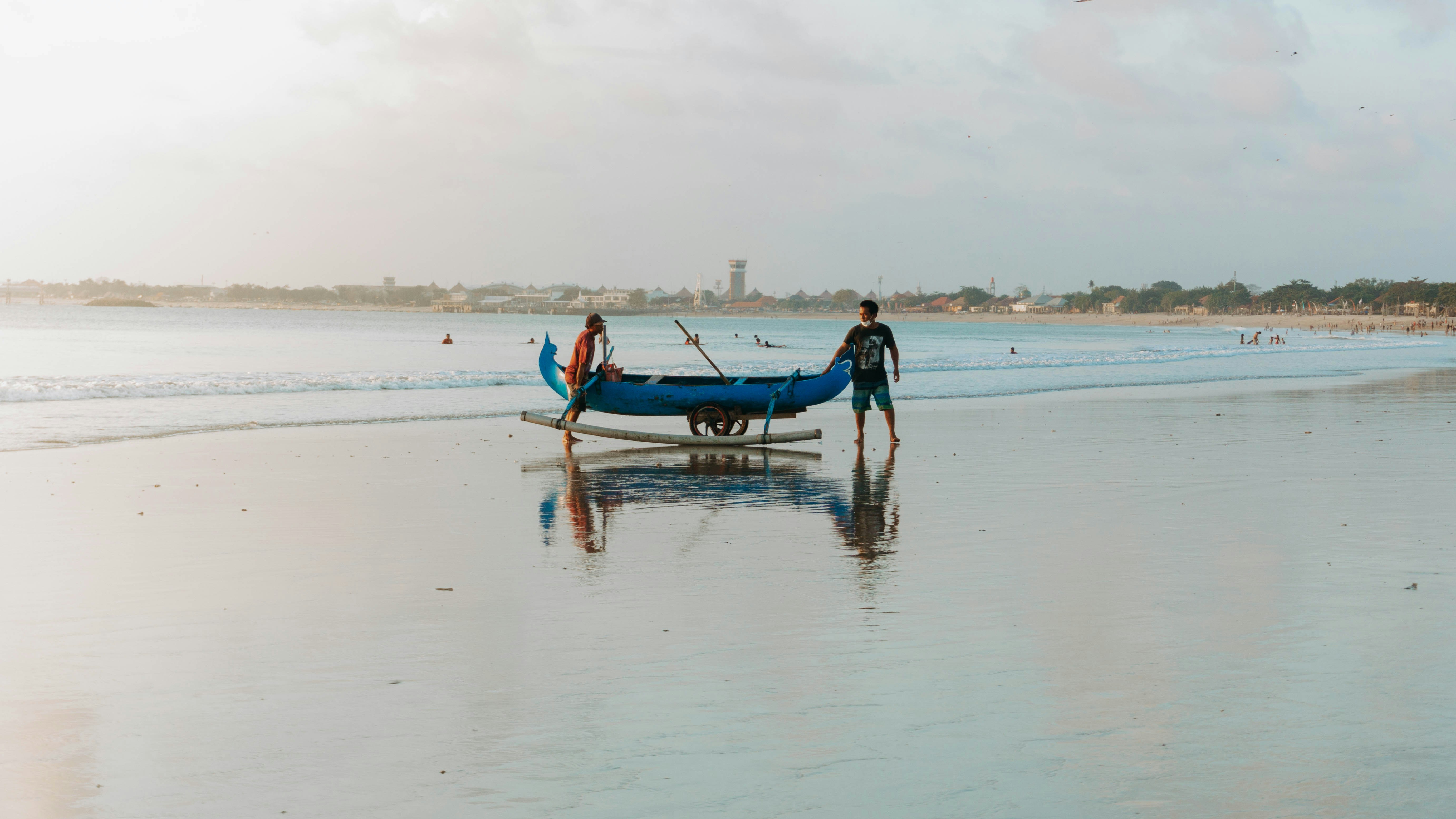 2 men and woman riding on boat on sea shore during daytime